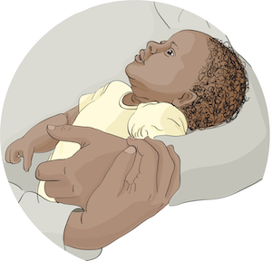 A baby being held in the arms of someone.